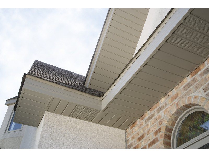 Light soffit panels beneath intersecting roof overhangs